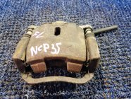 Суппорт левый передний TOYOTA BB NCP35