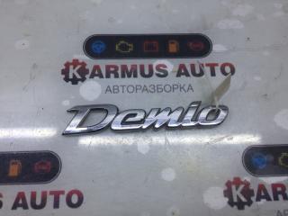 Эмблема задняя Mazda Demio